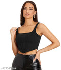 Black sleeveless corset crop top, black leather pants and gold earrings, exuding a stylish and bold vibe. Black corset crop top for girls