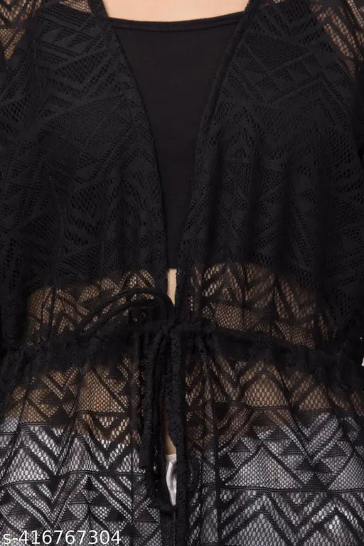 Close-up of a black lace cardigan with geometric patterns over a black top. It features a front tie, offering a stylish and elegant look.