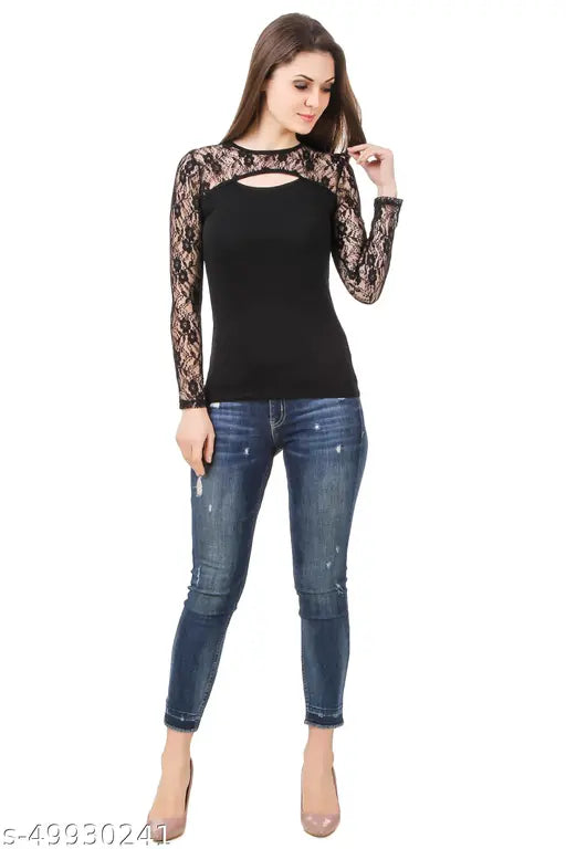 black lace long-sleeve top and distressed jeans. relaxed pose and a slight smile.