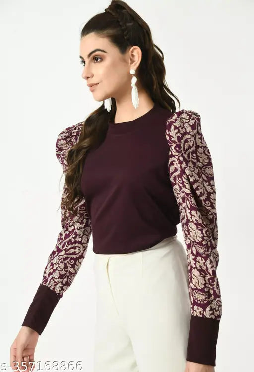  brown top with intricate floral-patterned puffed sleeves and white pants   white earrings.