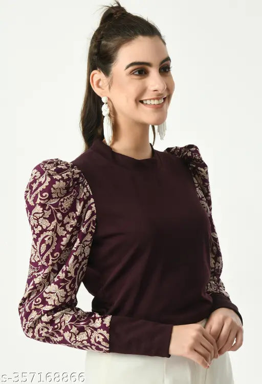  brown top with intricate floral-patterned puffed sleeves and white pants   white earrings.