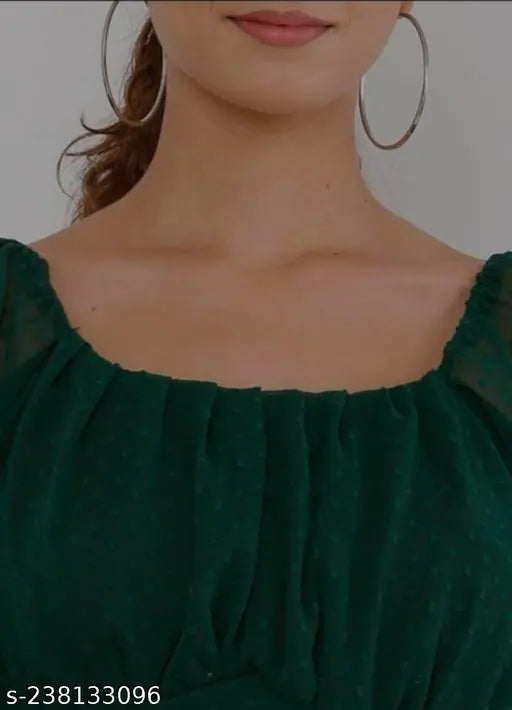 arge hoop earrings and a dark green textured blouse with a square neckline, exuding a stylish and elegant vibe.