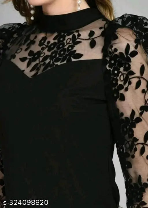 black dress featuring sheer, floral-embroidered sleeves and a matching neckline. The style is elegant and sophisticated.