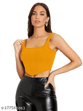 gold sleeveless corset crop top, black leather pants and gold earrings, exuding a stylish and bold vibe.