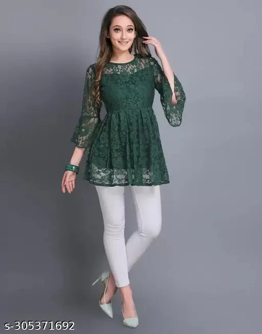 green lace layering top with flared sleeves and white pants, exuding a cheerful, confident tone.