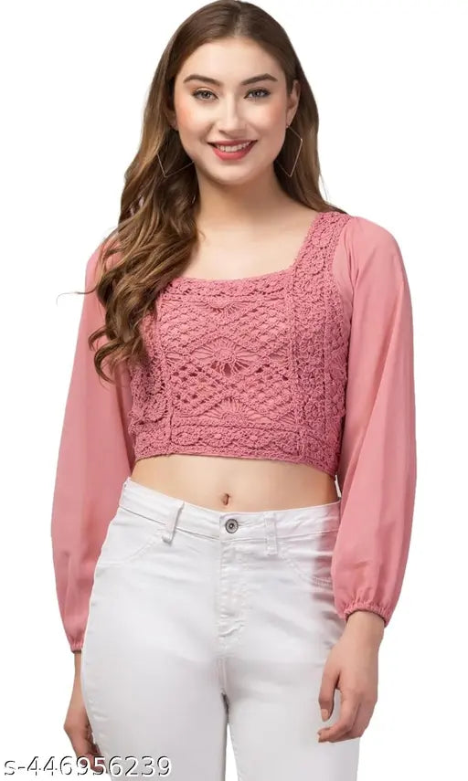 pink, crochet-patterned, long-sleeve crop top with white jeans. The image conveys a casual and cheerful tone.