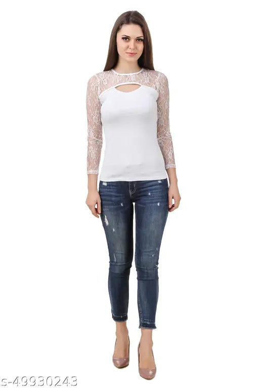 white lace long-sleeve top and distressed jeans. relaxed pose and a slight smile.