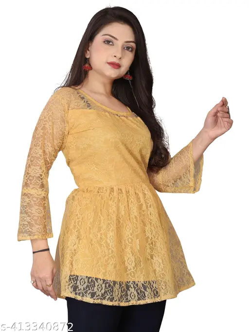 yellow lace tunic with three-quarter sleeves, gazing forward confidently. The attire is stylish and elegant